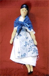Julia's imaginative dress made of scrap pieces of fabric on a repro wooden penny doll. Photo by Lorraine Danischewski.