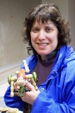 Susan Horwich, club member, shows her early wood swimming toy of unknown circa, which could have been made in the 1860's.
